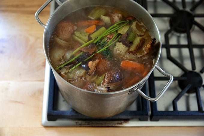 Turkey stock simmering on a stovetop.