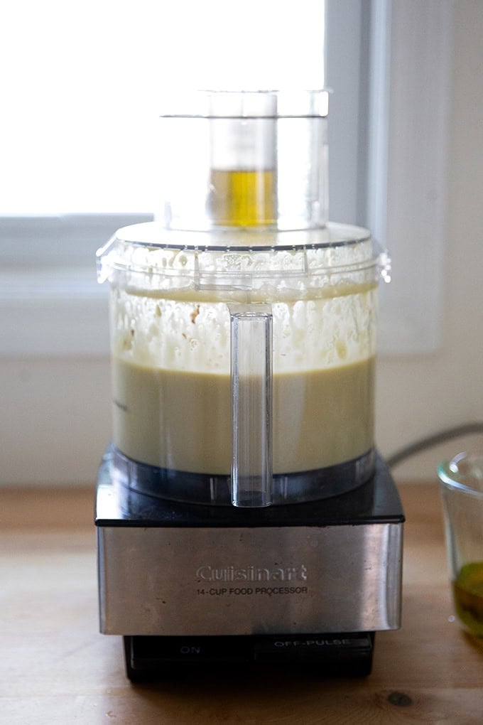A food processor with oil streaming down the food chute.