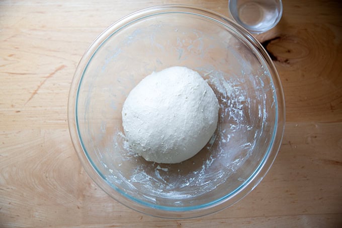 A ball of sandwich bread in a large glass bowl.