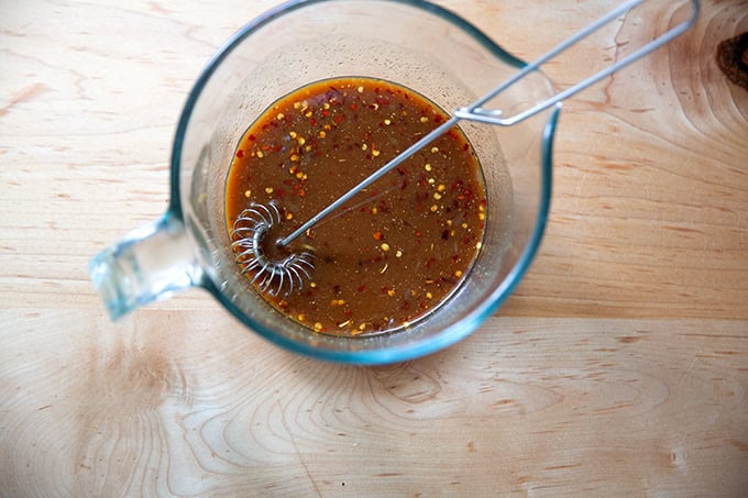 Whisked miso-lime sauce in a 4-cup measure.