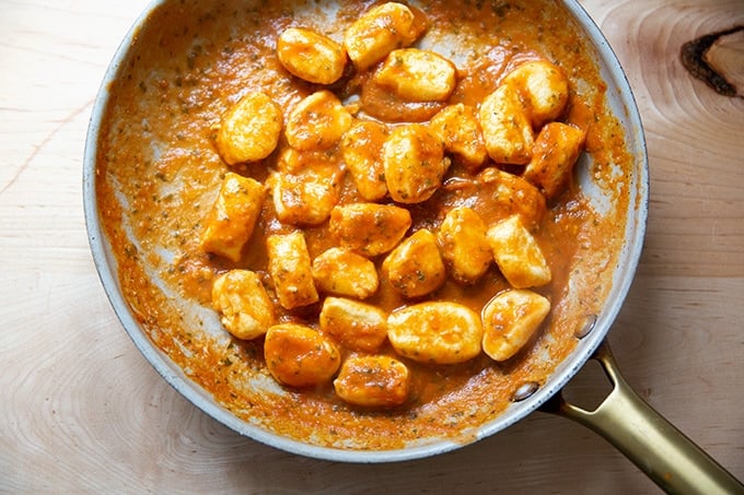 A skillet holding tomato sauce-tossed ricotta gnocchi.