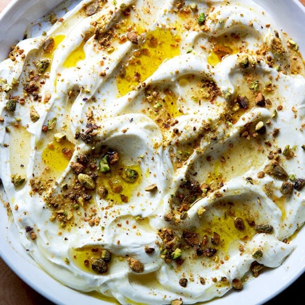 A platter of whipped ricotta with honey, olive oil, and pistachios.