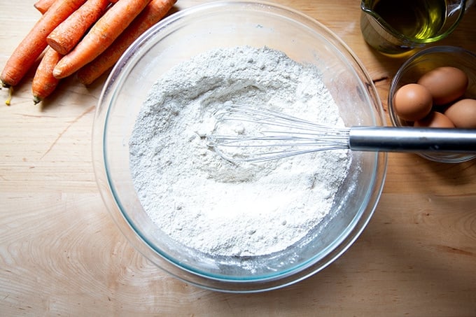 A bowl of whisked together dry ingredients to make carrot cake.