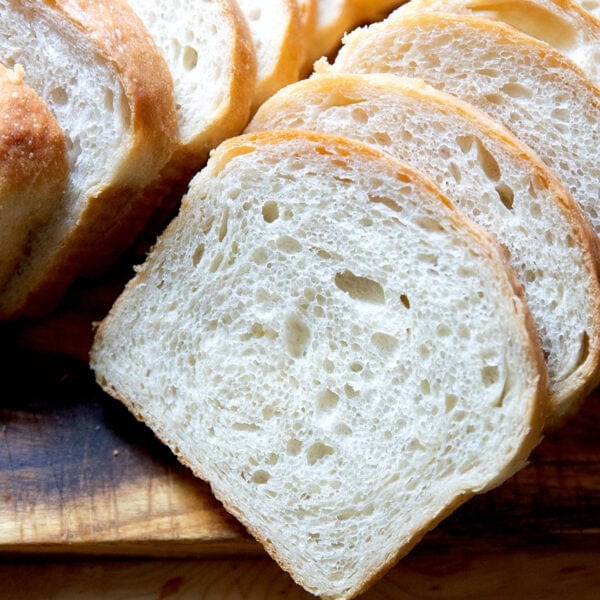 Sliced sourdough discard toasting bread on a cutting board.