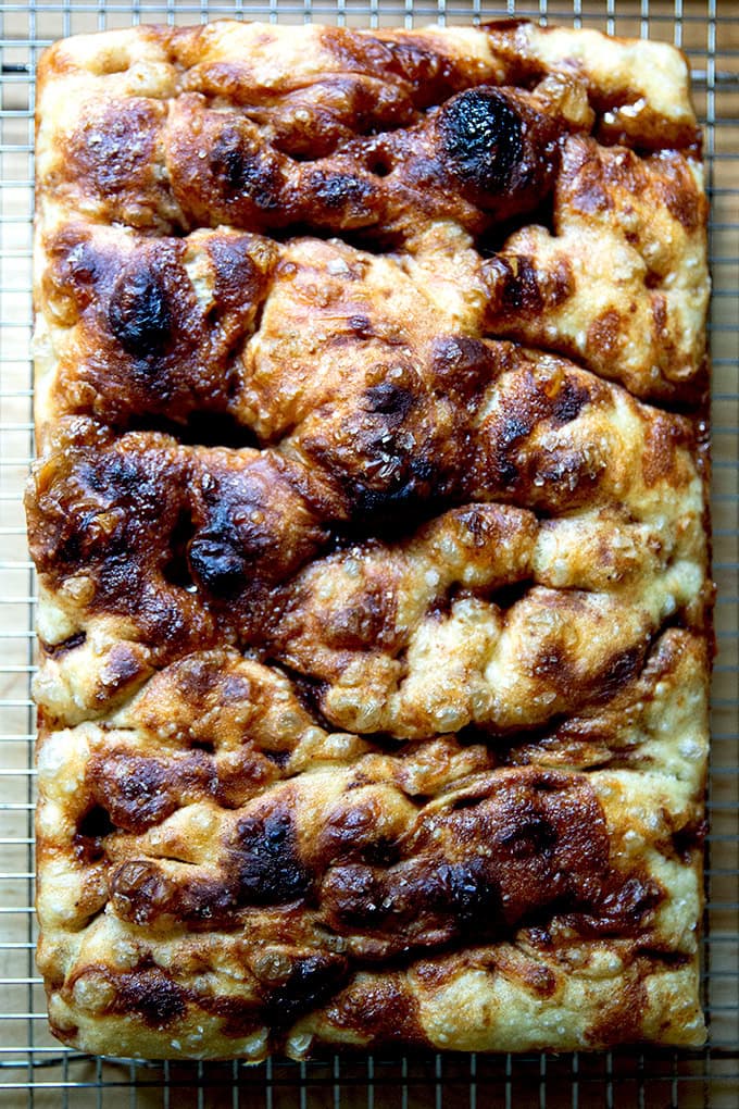 Just-baked cinnamon-sugar focaccia on a cooling rack.