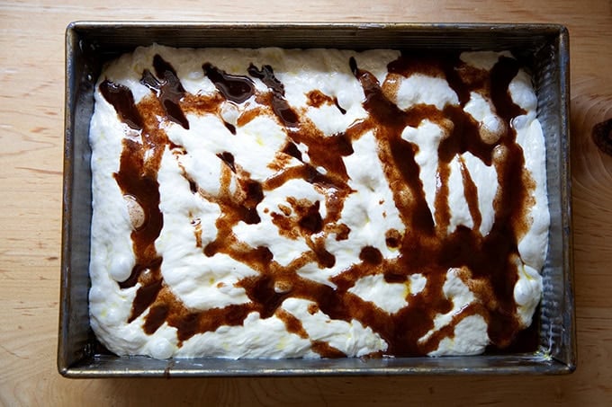 Focaccia dough topped with cinnamon-sugar butter mixture.