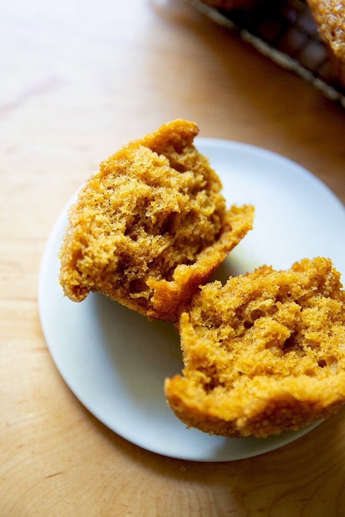 A halved pumpkin muffin on a plate.