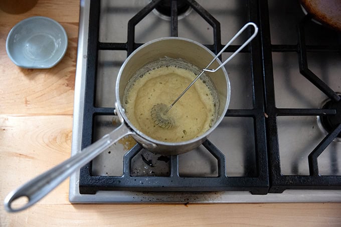 A small saucepan heating a small amount of butter and flour together for a roux.