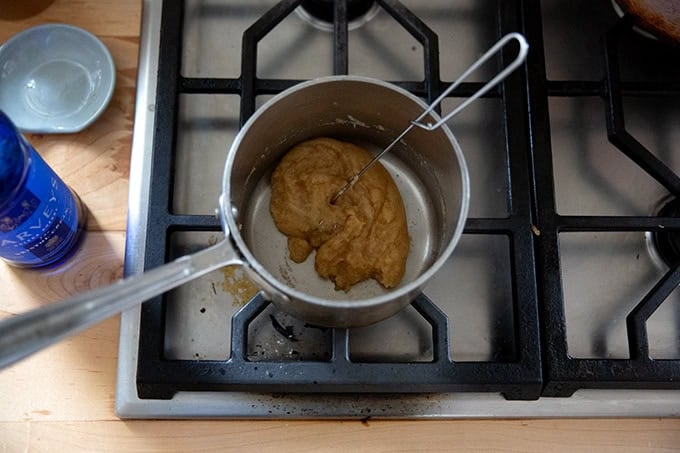 A roux in a small saucepan on the stovetop with Sherry added all whisked together.