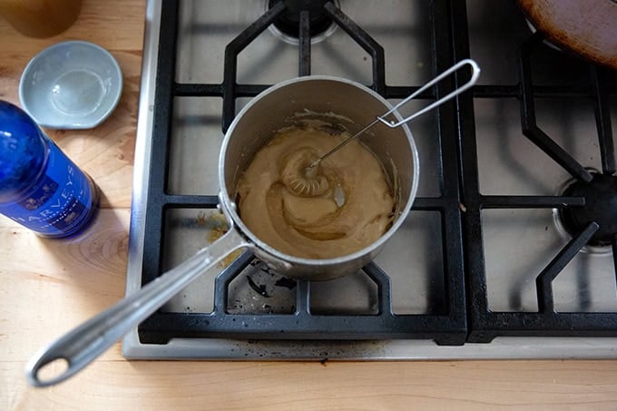 A roux in a small saucepan on the stovetop with Sherry added.