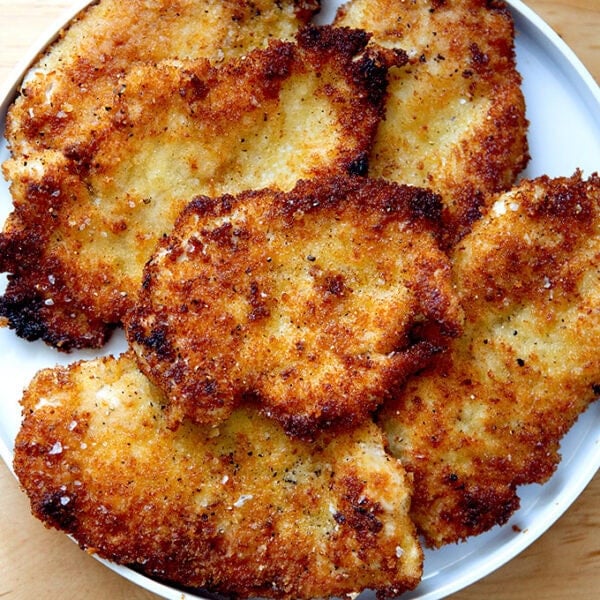 Just-cooked chicken cutlets on a plate.