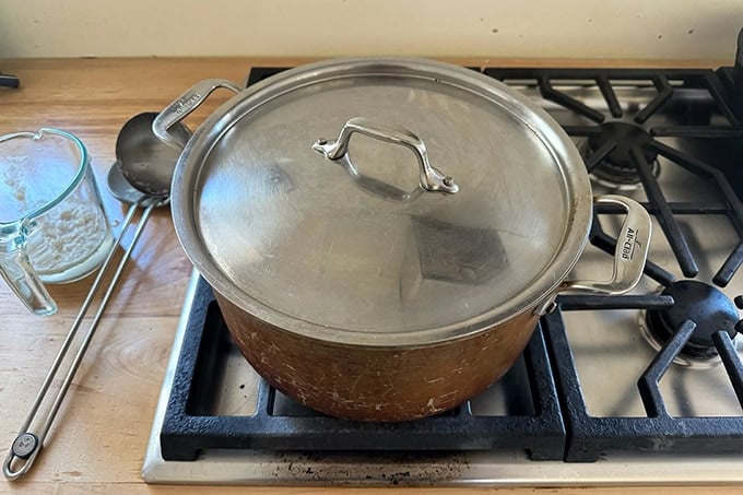 A large covered pot on the stovetop.