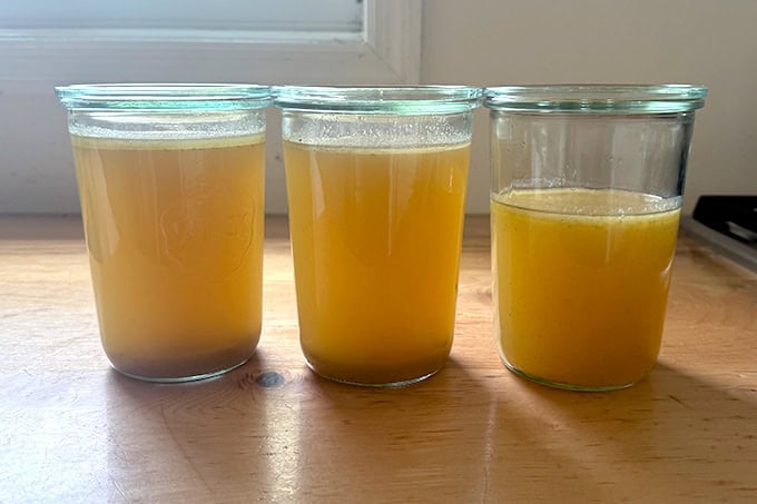 Three glass Weck jars fills with homemade chicken stock.