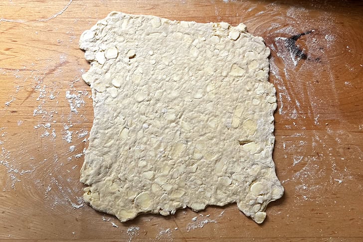 Croissant dough rolled out into a 10-inch square.