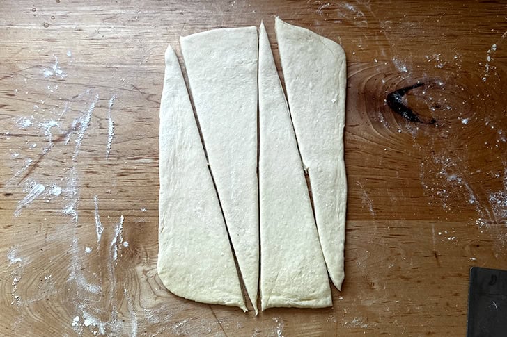 Croissant dough, rolled out and cut into four triangles.