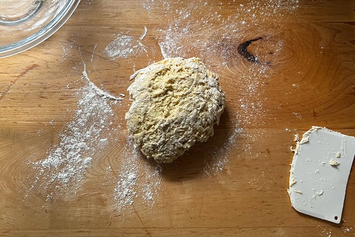 Croissant dough turned out onto a lightly floured work surface.
