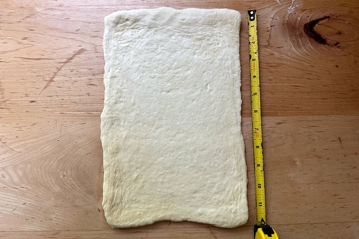 Kouign-Amann dough rolled into an 8x12-inch rectangle.