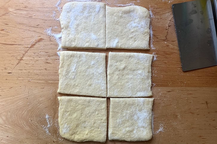 Kouign-Amann dough rolled into an 8x12-inch rectangle, sugared, and cut into 6 equal squares.