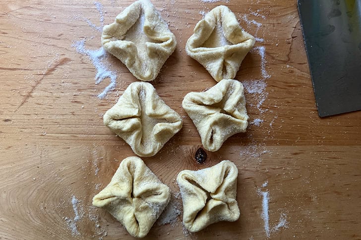 Six unbaked Kouign-Amann ready to be transferred to a muffin tin.