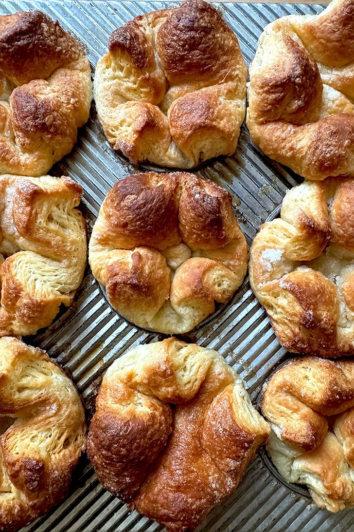 A muffin tin filled with just-baked Kouign-Amann.