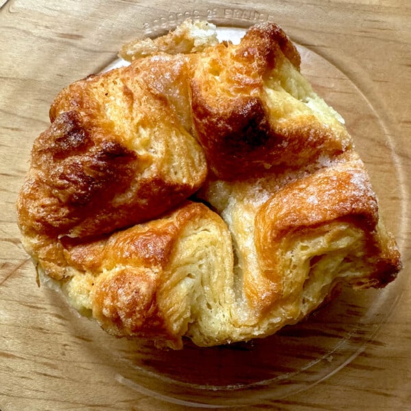 A single Kouign-Amann on a plate.